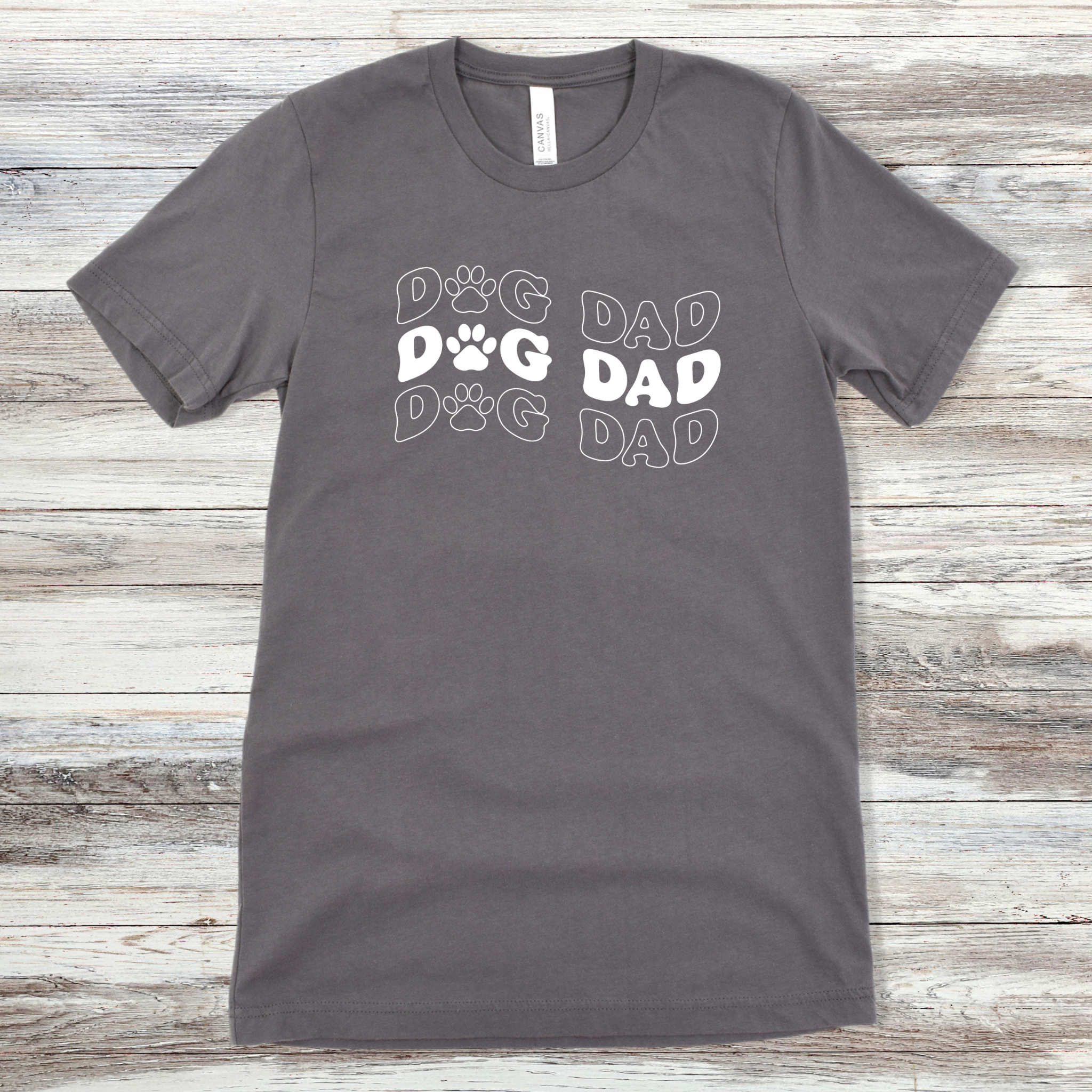 Text reading "Dog Dad" on an Asphalt Tee