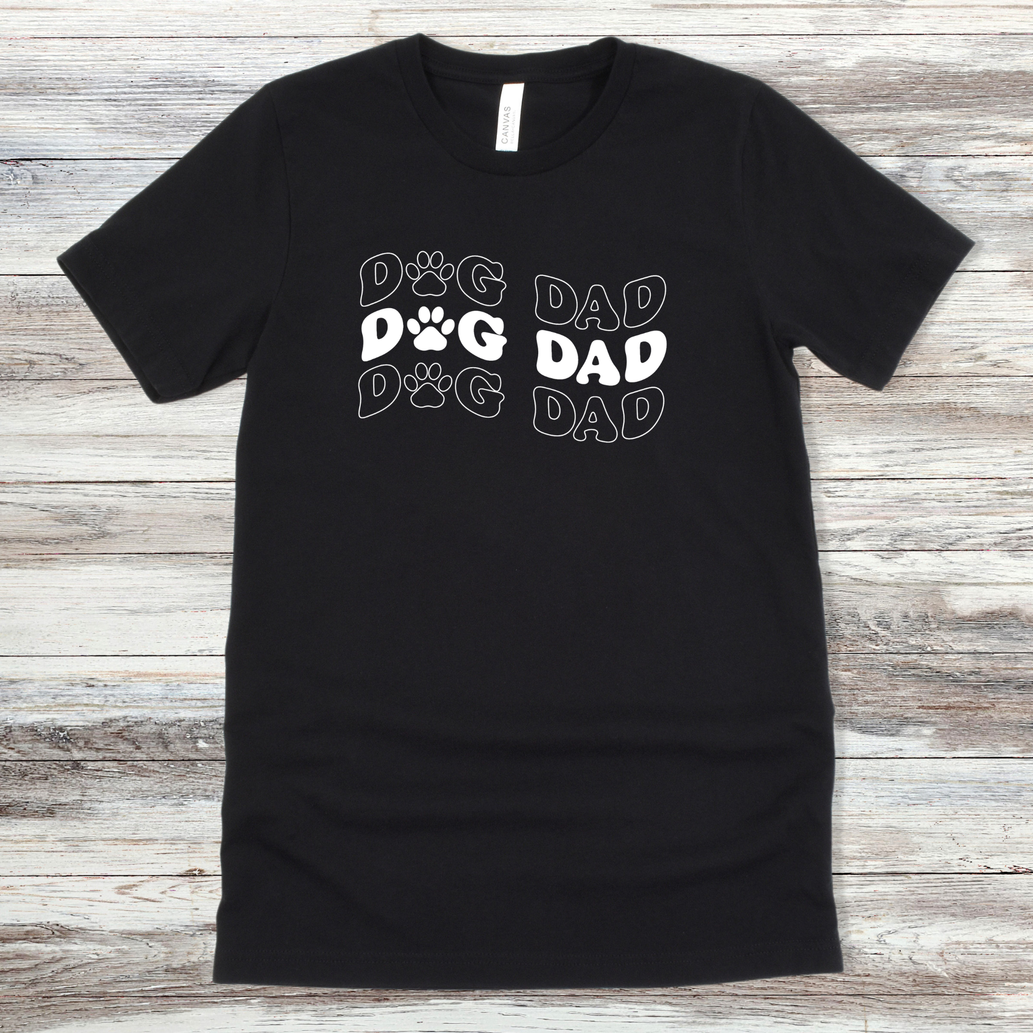 Text reading "Dog Dad" on a Black Tee